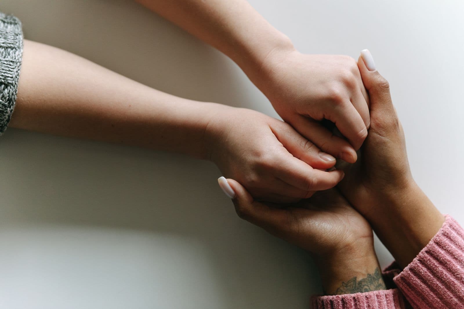 Two hands held together in comfort