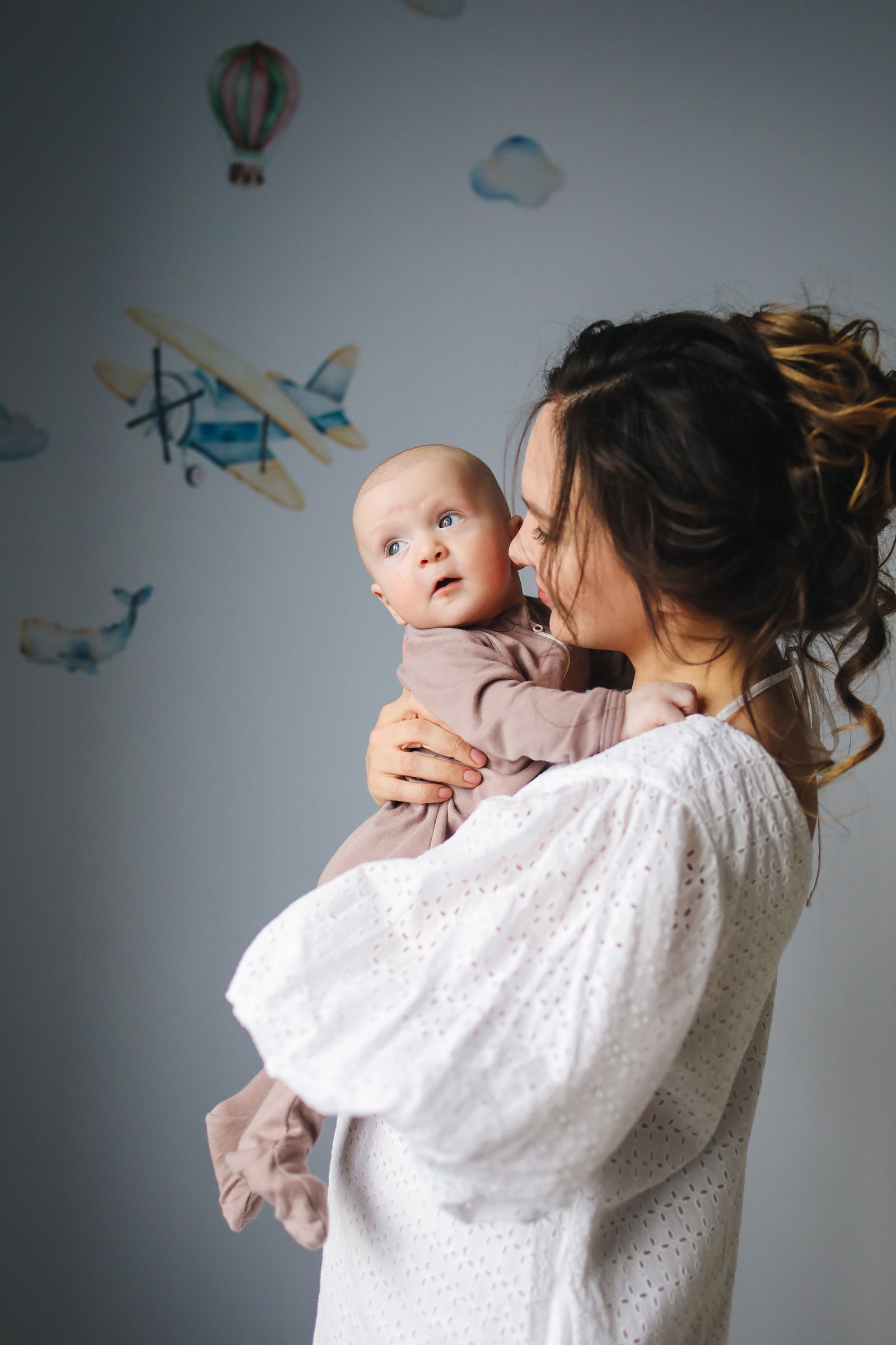 A mother holding her baby in soft light