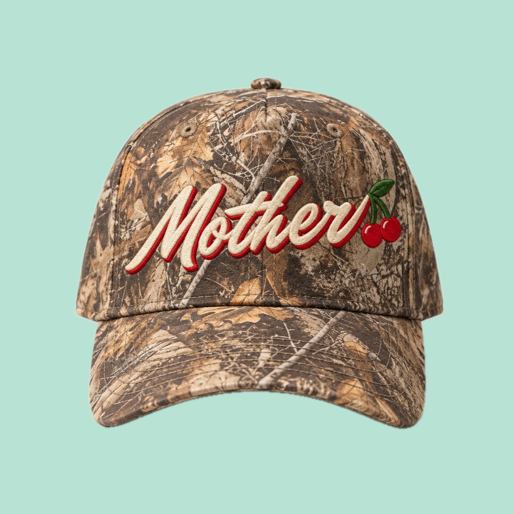 Front of the Mother Hat: camo cap with Mother in cream script outlined in red, with two red cherries